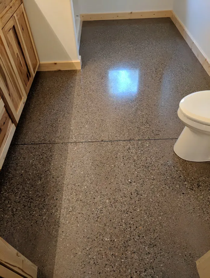 Concrete floor mid-grind during a polishing prep pass
