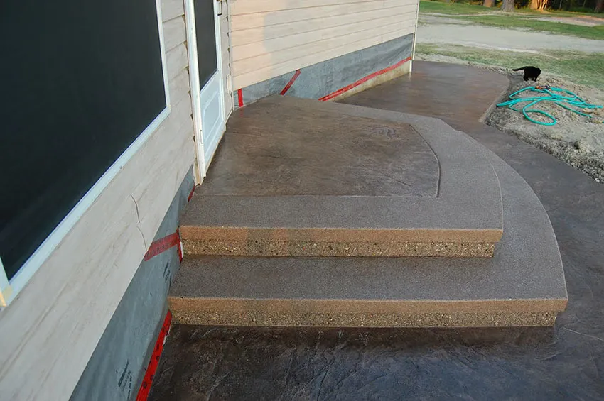 Decorative stamped concrete steps against a home